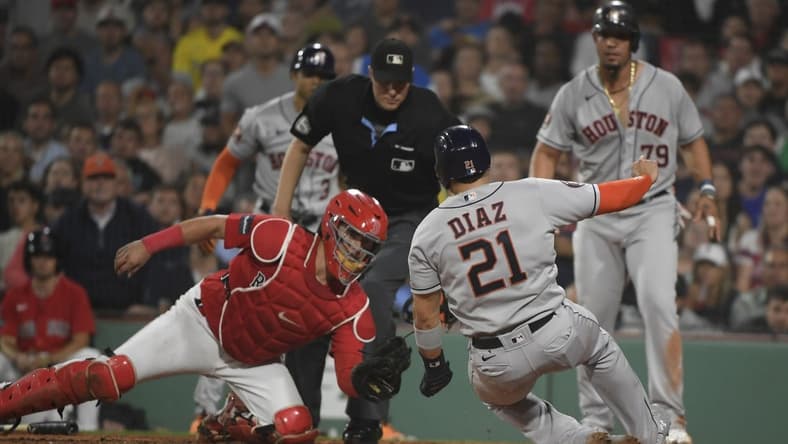 Aug 29, 2023; Boston, Massachusetts, USA;  Houston Astros catcher Yainer Diaz (21) slides safely into home plate before the tag of Boston Red Sox catcher Reese McGuire (3) during the sixth inning at Fenway Park. Mandatory Credit: Bob DeChiara-USA TODAY Sports