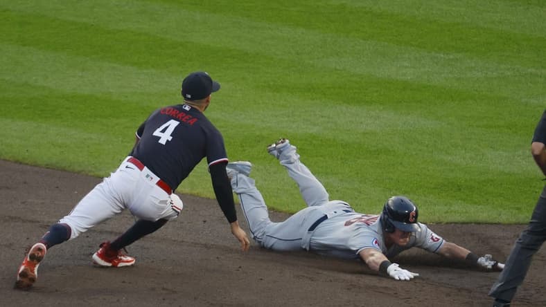 Aug 29, 2023; Minneapolis, Minnesota, USA; Cleveland Guardians first baseman Kole Calhoun (26) slides into second base for a double before Minnesota Twins shortstop Carlos Correa (4) can tag him in the third inning at Target Field. Mandatory Credit: Bruce Kluckhohn-USA TODAY Sports