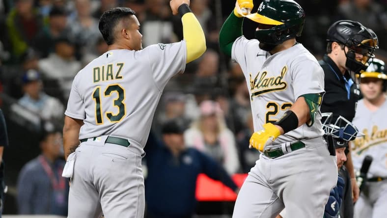 Aug 29, 2023; Seattle, Washington, USA; Oakland Athletics third baseman Jordan Diaz (13) and catcher Shea Langeliers (23) celebrate after Langeliers hit a 2-run home run against the Seattle Mariners during the second inning at T-Mobile Park. Mandatory Credit: Steven Bisig-USA TODAY Sports
