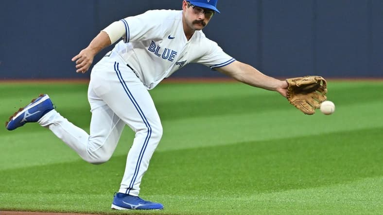 Aug 29, 2023; Toronto, Ontario, CAN;  Toronto Blue Jays second baseman Davis Schneider (36) cannot reach a ball hit for a single by Washington Nationals first baseman Dominic Smith (not pictured) in the second inning at Rogers Centre. Mandatory Credit: Dan Hamilton-USA TODAY Sports