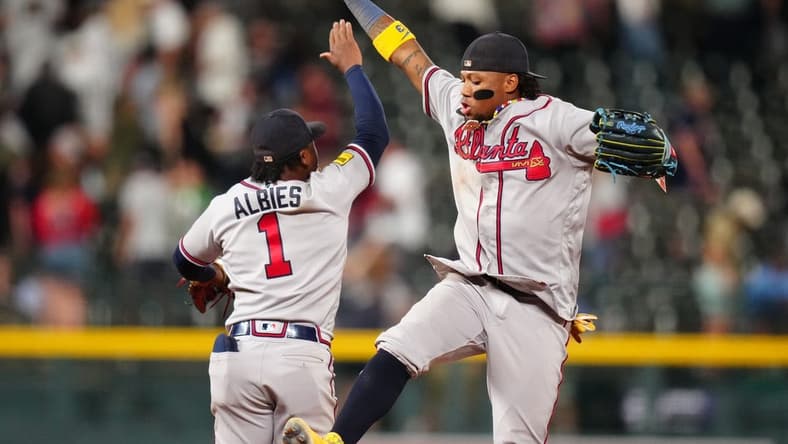 Aug 29, 2023; Denver, Colorado, USA; Atlanta Braves right fielder Ronald Acuna Jr. (13) and second baseman Ozzie Albies (1) celebrate defeating the Colorado Rockies at Coors Field. Mandatory Credit: Ron Chenoy-USA TODAY Sports