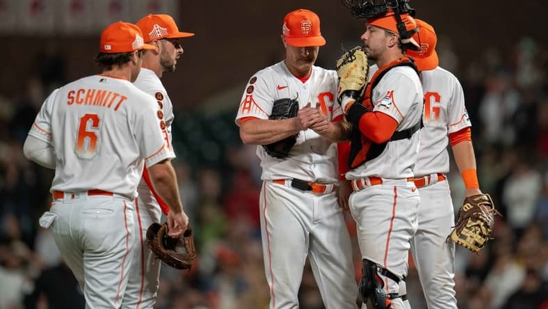 Aug 29, 2023; San Francisco, California, USA;  San Francisco Giants starting pitcher Alex Cobb (38) talks it over with San Francisco Giants catcher Patrick Bailey (14) and teammates during the ninth inning against the Cincinnati Reds at Oracle Park. Mandatory Credit: Neville E. Guard-USA TODAY Sports