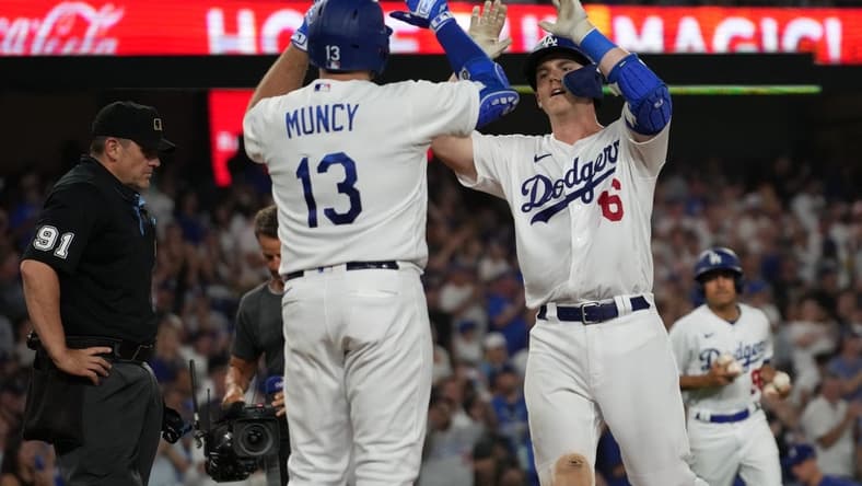Aug 29, 2023; Los Angeles, California, USA; Los Angeles Dodgers catcher Will Smith (16) celebrates with third baseman Max Muncy (13) after hitting a home run in the sixth inning against the Arizona Diamondbacks at Dodger Stadium. Mandatory Credit: Kirby Lee-USA TODAY Sports