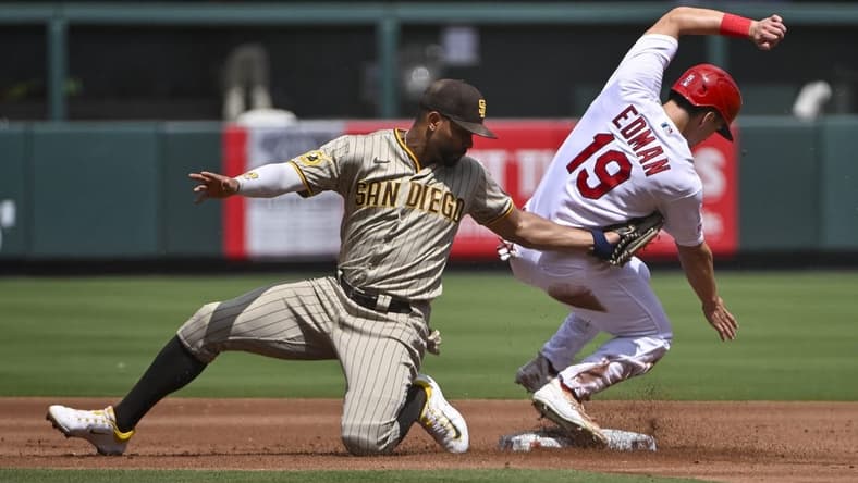 Aug 30, 2023; St. Louis, Missouri, USA;  St. Louis Cardinals center fielder Tommy Edman (19) slides safely past the tag of San Diego Padres shortstop Xander Bogaerts (2) for a stolen base during the first inning at Busch Stadium. Mandatory Credit: Jeff Curry-USA TODAY Sports