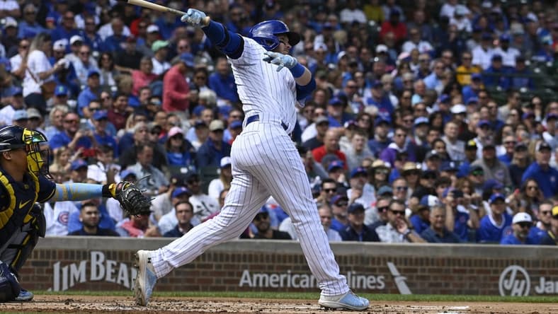 Aug 30, 2023; Chicago, Illinois, USA; Chicago Cubs left fielder Ian Happ (8) hits an RBI double against the Milwaukee Brewers during the first inning at Wrigley Field. Mandatory Credit: Matt Marton-USA TODAY Sports
