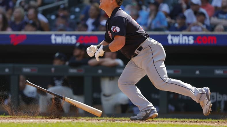 Aug 30, 2023; Minneapolis, Minnesota, USA; Cleveland Guardians first baseman Kole Calhoun (56) hits a three-run home run against the Minnesota Twins in the tenth inning at Target Field. Mandatory Credit: Bruce Kluckhohn-USA TODAY Sports