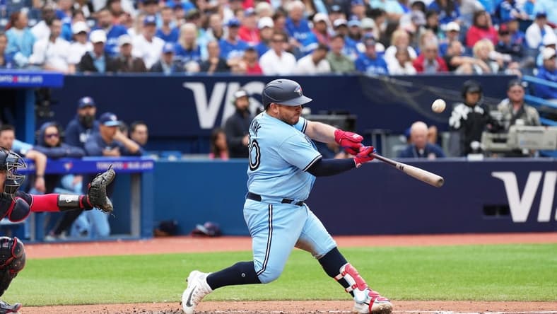 Aug 30, 2023; Toronto, Ontario, CAN; Toronto Blue Jays catcher Alejandro Kirk (30) hits an RBI sacrifice fly ball against the Washington Nationals during the seventh inning at Rogers Centre. Mandatory Credit: Nick Turchiaro-USA TODAY Sports