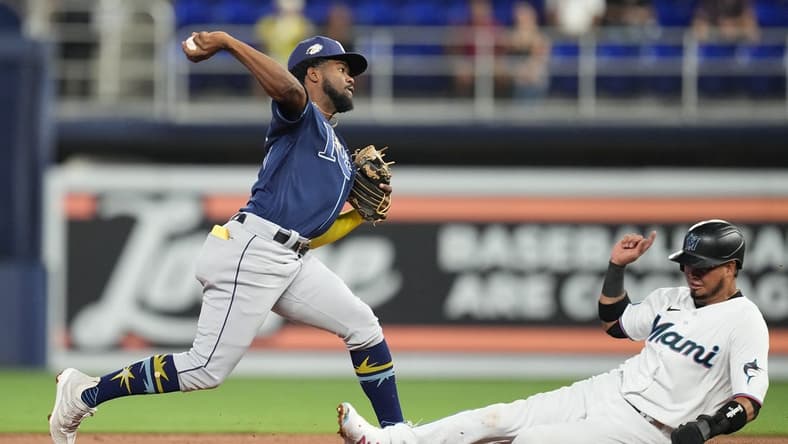Aug 30, 2023; Miami, Florida, USA; Tampa Bay Rays shortstop Osleivis Basabe (37) completes a double play as Miami Marlins second baseman Luis Arraez (3) slides into second base in the first inning at loanDepot Park. Mandatory Credit: Jim Rassol-USA TODAY Sports
