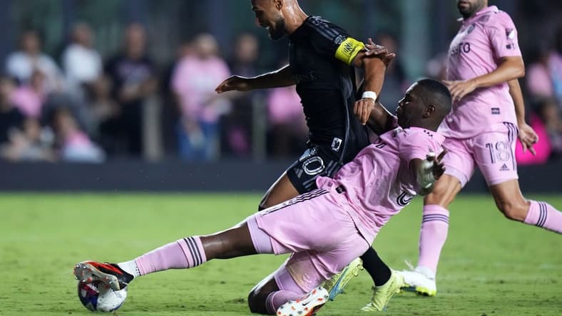Aug 30, 2023; Fort Lauderdale, Florida, USA; Inter Miami defender Kamal Miller (31) slide tackles Nashville SC midfielder Hany Mukhtar (10) during the second half at DRV PNK Stadium. Mandatory Credit: Rich Storry-USA TODAY Sports