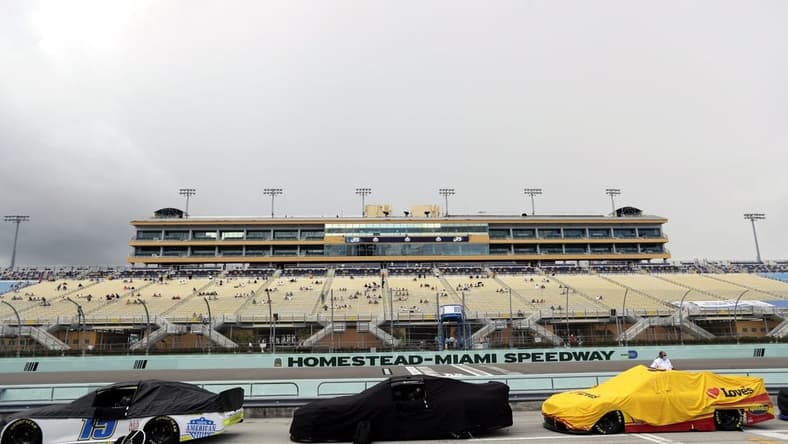 Jun 14, 2020; Homestead, Florida, USA; A general view as cars are covered during a rain delay prior to the NASCAR Cup series race at Homestead-Miami Speedway. Mandatory Credit: Wilfredo Lee/Pool Photo via USA TODAY Network