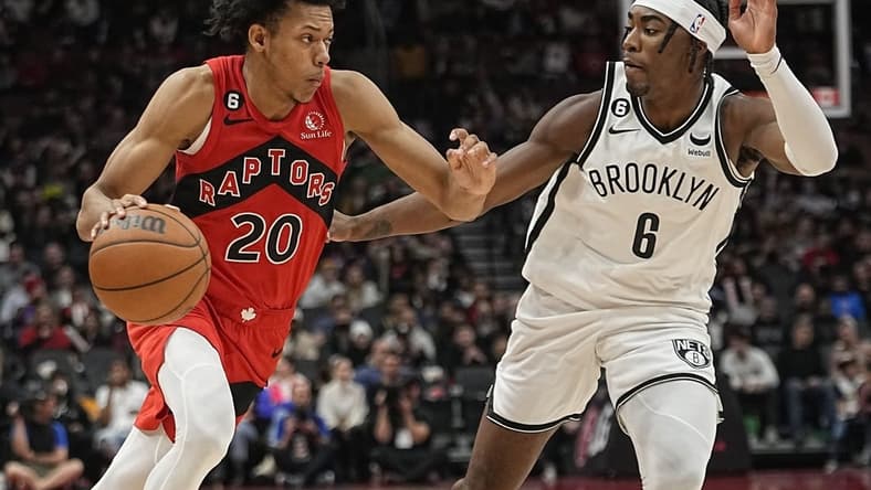 Nov 23, 2022; Toronto, Ontario, CAN; Toronto Raptors guard Jeff Dowtin (20) drives to the net against Brooklyn Nets forward David Duke Jr. (6) during the second half at Scotiabank Arena. Mandatory Credit: John E. Sokolowski-USA TODAY Sports