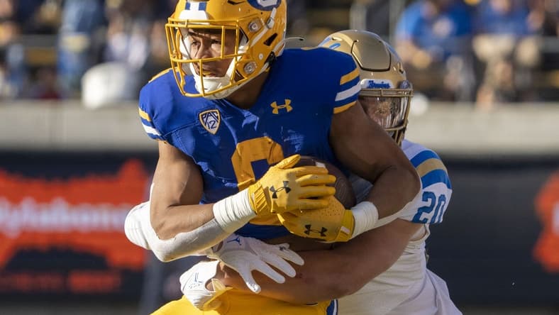 November 25, 2022; Berkeley, California, USA; California Golden Bears running back Jaydn Ott (6) is tackled by UCLA Bruins linebacker Kain Medrano (20) during the second quarter at California Memorial Stadium. Mandatory Credit: Kyle Terada-USA TODAY Sports