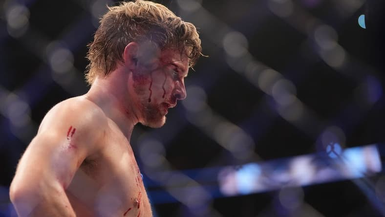 Dec 10, 2022; Las Vegas, Nevada, USA; Bryce Mitchell (red gloves) reacts after the fight against Ilia Topuria (blue gloves) during UFC 282 at T-Mobile Arena. Mandatory Credit: Stephen R. Sylvanie-USA TODAY Sports
