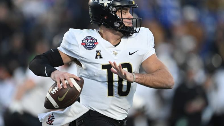 Dec 28, 2022; Annapolis, Maryland, USA; UCF quarterback John Rhys Plumlee (10) throws own the run against Duke in the 2022 Military Bowl at Navy-Marine Corps Memorial Stadium. Mandatory Credit: Tommy Gilligan-USA TODAY Sports