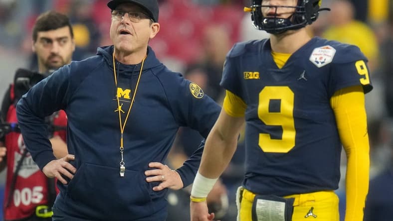 Dec 31, 2022; Glendale, Arizona, USA; Michigan Wolverines head coach Jim Harbaugh watches as J.J. McCarthy (9) warms up before they take on the TCU Horned Frogs in the Vrbo Fiesta Bowl at State Farm Stadium. Mandatory Credit: Joe Rondone-Arizona Republic

Ncaa Fiesta Bowl Game
