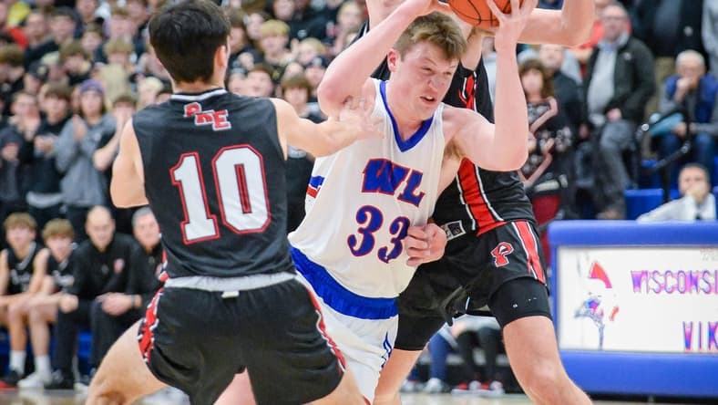 Wisconsin Lutheran guard Kon Knueppel (33) is fouled as he drives to the basket between Pewaukee guard Karson Osterman (10) and forward Milan Momcilovic (22) on Tuesday January 3, 2023, at Wisconsin Lutheran High School in Milwaukee, Wisconsin.
Pewaukee