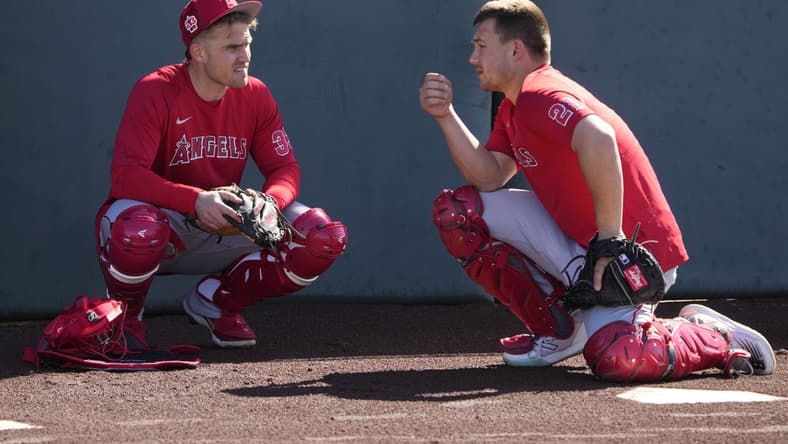 Feb 15, 2023; Tempe, AZ, USA; Los Angeles Angels catchers' Max Stassi (33) and Matt Thaiss (21) talk during spring training camp. Mandatory Credit: Rick Scuteri-USA TODAY Sports