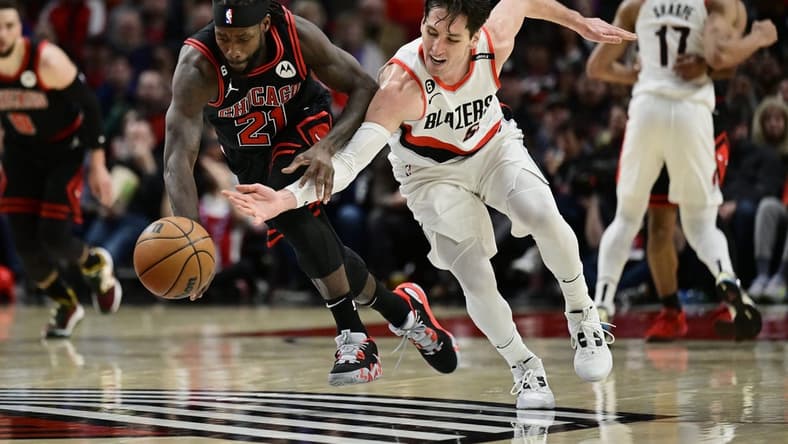 Mar 24, 2023; Portland, Oregon, USA; Chicago Bulls guard Patrick Beverley (21) steals the basketball away from Portland Trail Blazers guard Ryan Arcidiacono (51) during the first half at Moda Center. Mandatory Credit: Troy Wayrynen-USA TODAY Sports
