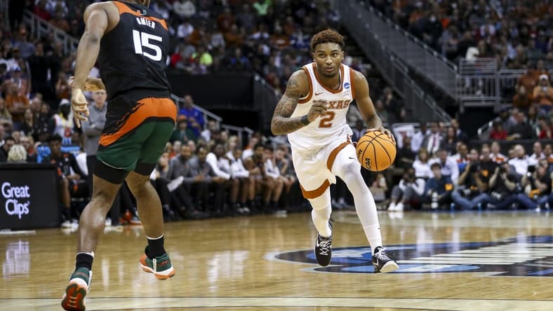Mar 26, 2023; Kansas City, MO, USA;  Miami Hurricanes forward Norchad Omier (15) defends as Texas Longhorns guard Arterio Morris (2) dribbles the ball in the second half at the T-Mobile Center. Mandatory Credit: William Purnell-USA TODAY Sports