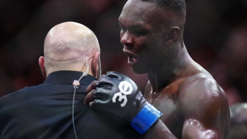 Apr 8, 2023; Miami, Florida, USA; Israel Adesanya (blue gloves) reacts to defeating Alex Pereira (red gloves) during UFC 287 at Miami-Dade Arena. Mandatory Credit: Rich Storry-USA TODAY Sports