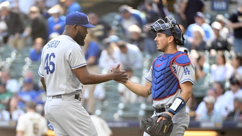 May 10, 2023; Milwaukee, Wisconsin, USA; Los Angeles Dodgers relief pitcher Wander Suero (46) and Los Angeles Dodgers catcher Austin Barnes (15) celebrate a win over the Milwaukee Brewers at American Family Field. Mandatory Credit: Michael McLoone-USA TODAY Sports
