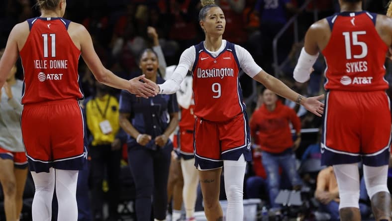 May 19, 2023; Washington, District of Columbia, USA; Washington Mystics guard Natasha Cloud (9) celebrates with Mystics forward Elena Delle Donne (11) and Mystics guard Brittney Sykes (15) in the fourth quarter at Entertainment & Sports Arena. Mandatory Credit: Geoff Burke-USA TODAY Sports