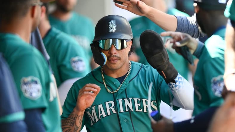 Jul 22, 2023; Seattle, Washington, USA; Seattle Mariners second baseman Kolten Wong (16) celebrates scoring a run against the Toronto Blue Jays in the seventh inning at T-Mobile Park. Mandatory Credit: Steven Bisig-USA TODAY Sports