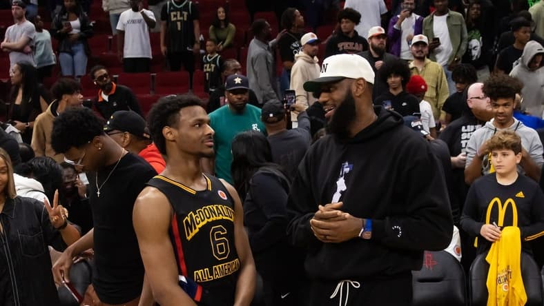 Mar 28, 2023; Houston, TX, USA; West guard Bronny James (6) with father LeBron James following the McDonald's All American Boy's high school basketball game at Toyota Center. Mandatory Credit: Mark J. Rebilas-USA TODAY Sports