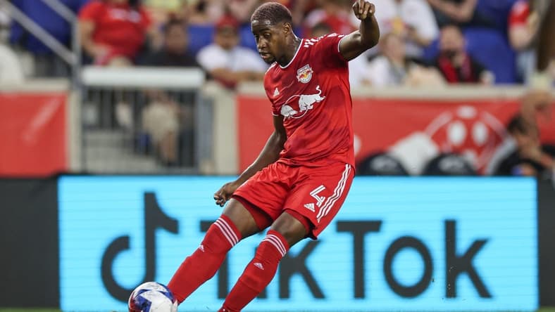 Aug 20, 2023; Harrison, New Jersey, USA; New York Red Bulls defender Andres Reyes (4) kicks the ball against D.C. United during the first half at Red Bull Arena. Mandatory Credit: Vincent Carchietta-USA TODAY Sports