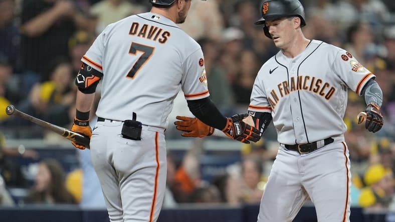 Aug 31, 2023; San Diego, California, USA;  San Francisco Giants right fielder Mike Yastrzemski (right) is congratulated by third baseman J.D. Davis (7) after hitting a home run against the San Diego Padres during the fifth inning at Petco Park. Mandatory Credit: Ray Acevedo-USA TODAY Sports