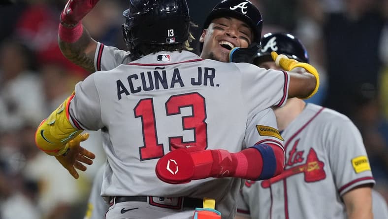 Aug 31, 2023; Los Angeles, California, USA; Atlanta Braves right fielder Ronald Acuna Jr. (13) is greeted after hitting a grand slam home run in the second inning against the Los Angeles Dodger at Dodger Stadium. Mandatory Credit: Kirby Lee-USA TODAY Sports