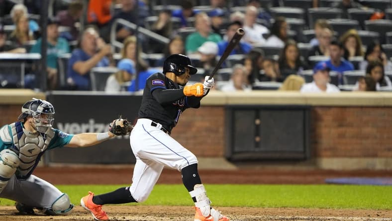 Sep 1, 2023; New York City, New York, USA;  New York Mets shortstop Francisco Lindor (12) hits a single against the Seattle Mariners during the eighth inning at Citi Field. Mandatory Credit: Gregory Fisher-USA TODAY Sports