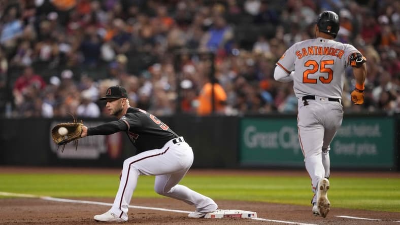 Sep 1, 2023; Phoenix, Arizona, USA; Arizona Diamondbacks first baseman Christian Walker (53) fields a throw to force out Baltimore Orioles right fielder Anthony Santander (25) during the first inning at Chase Field. Mandatory Credit: Joe Camporeale-USA TODAY Sports