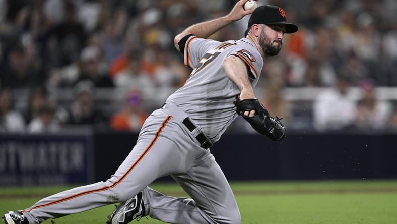 Sep 1, 2023; San Diego, California, USA; San Francisco Giants relief pitcher Alex Wood (57) throws to first base on a ground out by San Diego Padres designated hitter Manny Machado (not pictured) during the fifth inning at Petco Park. Mandatory Credit: Orlando Ramirez-USA TODAY Sports