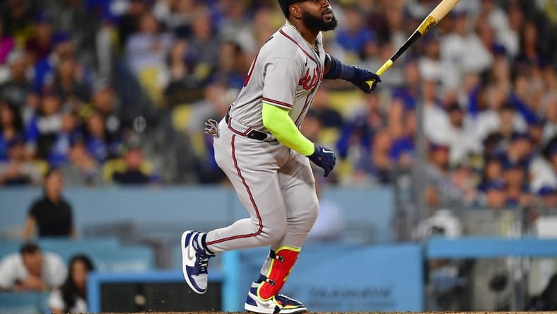 September 1, 2023; Los Angeles, California, USA; Atlanta Braves designated hitter Marcell Ozuna (20) hits an RBI single against the Los Angeles Dodgers during the fifth inning at Dodger Stadium. Mandatory Credit: Gary A. Vasquez-USA TODAY Sports