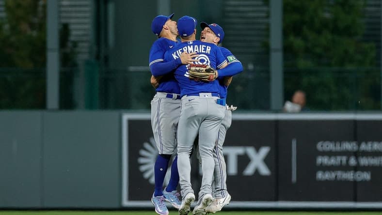 Sep 1, 2023; Denver, Colorado, USA; Toronto Blue Jays center fielder Kevin Kiermaier (39) and right fielder George Springer (4) and left fielder Daulton Varsho (25) celebrate after the game against the Colorado Rockies at Coors Field. Mandatory Credit: Isaiah J. Downing-USA TODAY Sports