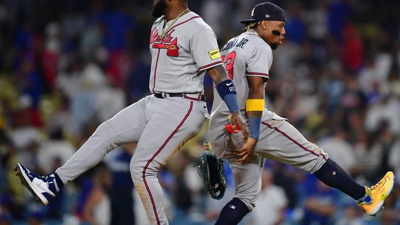 September 1, 2023; Los Angeles, California, USA; Atlanta Braves designated hitter Marcell Ozuna (20) and right fielder Ronald Acuna Jr. (13) celebrate the victory against the Los Angeles Dodgers at Dodger Stadium. Mandatory Credit: Gary A. Vasquez-USA TODAY Sports