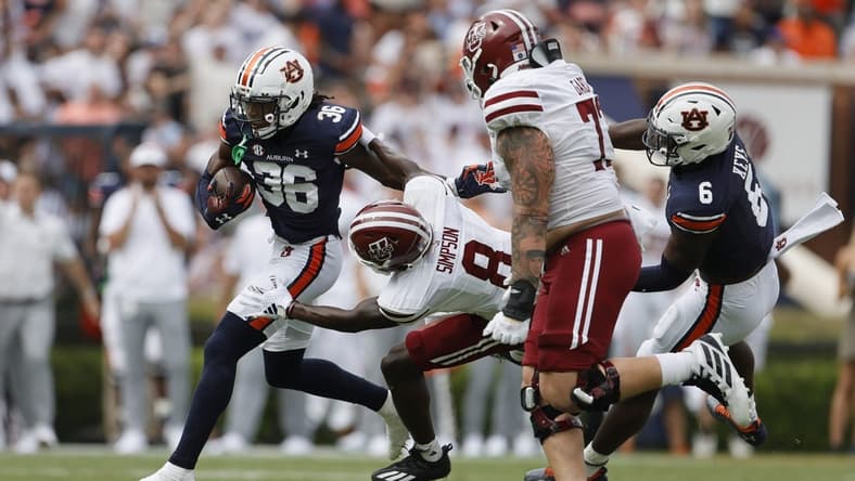 Sep 2, 2023; Auburn, Alabama, USA;  Massachusetts Minutemen wide receiver Anthony Simpson (8) moves in to tackle Auburn Tigers cornerback Jaylin Simpson (36) after Simpson recovered a fumble during the second quarter at Jordan-Hare Stadium. Mandatory Credit: John Reed-USA TODAY Sports