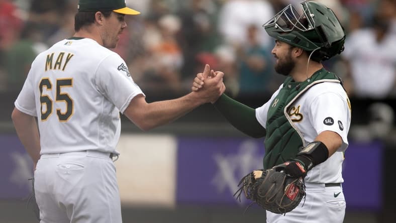 Sep 2, 2023; Oakland, California, USA; Oakland Athletics pitcher Trevor May (65) and catcher Shea Langeliers (23) celebrate their 2-1 victory over the Los Angeles Angels at Oakland-Alameda County Coliseum. Mandatory Credit: D. Ross Cameron-USA TODAY Sports