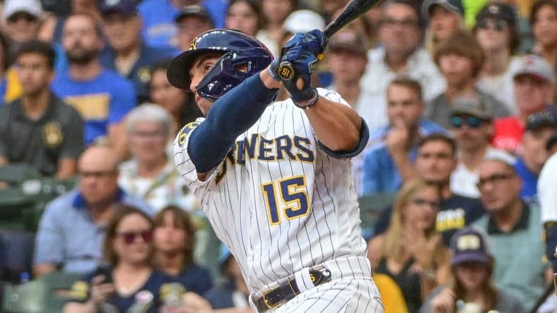 Sep 2, 2023; Milwaukee, Wisconsin, USA;  Milwaukee Brewers right fielder Tyrone Taylor (15) hits a double to drive in a run in the second inning against the Philadelphia Phillies at American Family Field. Mandatory Credit: Benny Sieu-USA TODAY Sports
