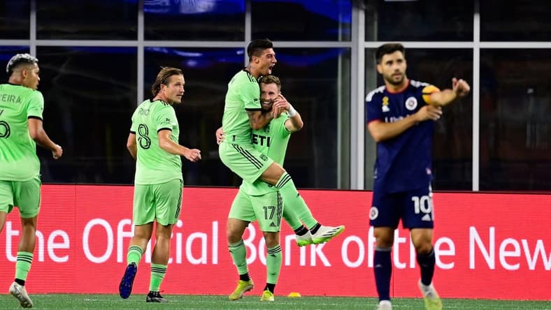 Sep 2, 2023; Foxborough, Massachusetts, USA; Austin FC midfielder Emiliano Rigoni (7) celebrates his goal by jumping to the arms of midfielder Jon Gallagher (17) during the first half at Gillette Stadium. Mandatory Credit: Eric Canha-USA TODAY Sports