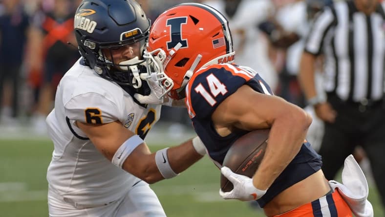 Sep 2, 2023; Champaign, Illinois, USA;  Toledo Rockets safety Nate Bauer (6) tries to tackle Illinois Fighting Illini wide receiver Casey Washington (14) during the first half at Memorial Stadium. Mandatory Credit: Ron Johnson-USA TODAY Sports