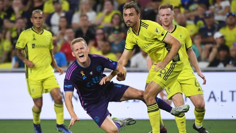 Sep 2, 2023; Nashville, Tennessee, USA; Charlotte FC forward Karol Swiderski (11) in action against Nashville SC defender Jack Maher (5) during the first half at Geodis Park. Mandatory Credit: Christopher Hanewinckel-USA TODAY Sports