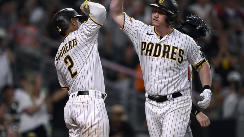 Sep 2, 2023; San Diego, California, USA; San Diego Padres first baseman Garrett Cooper (right) is congratulated by shortstop Xander Bogaerts (2) after hitting a three-run home run against the San Francisco Giants during the sixth inning at Petco Park. Mandatory Credit: Orlando Ramirez-USA TODAY Sports