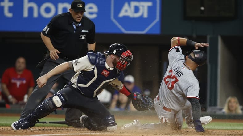 Sep 2, 2023; Arlington, Texas, USA; Minnesota Twins third baseman Royce Lewis (23) scores a run and avoids the tag of Texas Rangers catcher Jonah Heim (28) in the tenth inning at Globe Life Field. Mandatory Credit: Tim Heitman-USA TODAY Sports