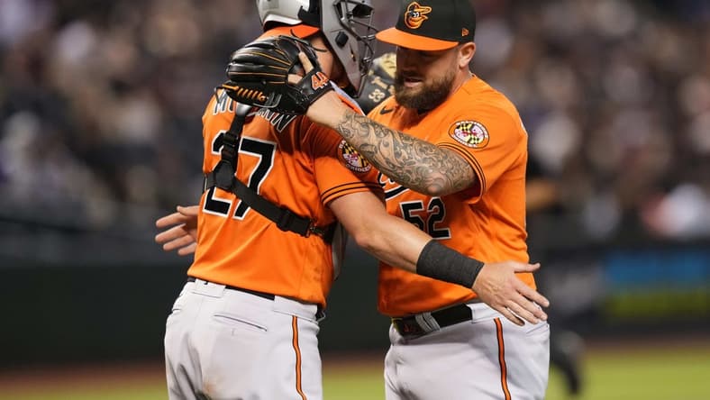 Sep 2, 2023; Phoenix, Arizona, USA; Baltimore Orioles relief pitcher Joey Krehbiel (52) hugs Baltimore Orioles catcher James McCann (27) after defeating the Arizona Diamondbacks at Chase Field. Mandatory Credit: Joe Camporeale-USA TODAY Sports