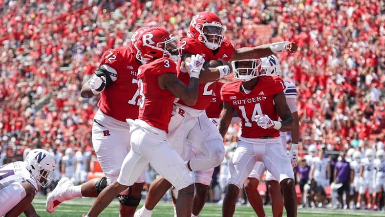 Sep 3, 2023; Piscataway, New Jersey, USA; Rutgers Scarlet Knights quarterback Gavin Wimsatt (2) celebrates his touchdown with teammates during the first half against the Northwestern Wildcats at SHI Stadium. Mandatory Credit: Vincent Carchietta-USA TODAY Sports