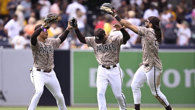 Sep 3, 2023; San Diego, California, USA; San Diego Padres left fielder Juan Soto (22) celebrates with center fielder Trent Grisham (1) and right fielder Fernando Tatis Jr. (23) after defeating the San Francisco Giants at Petco Park. Mandatory Credit: Orlando Ramirez-USA TODAY Sports