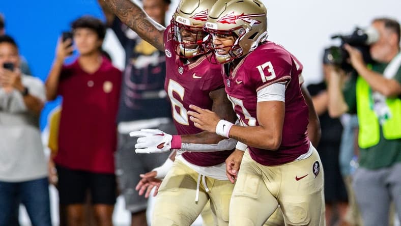 Florida State Seminoles tight end Jaheim Bell (6) and Florida State Seminoles quarterback Jordan Travis (13) celebrate a touchdown during a game against the LSU Tigers on Sunday, Sept. 3, 2023.