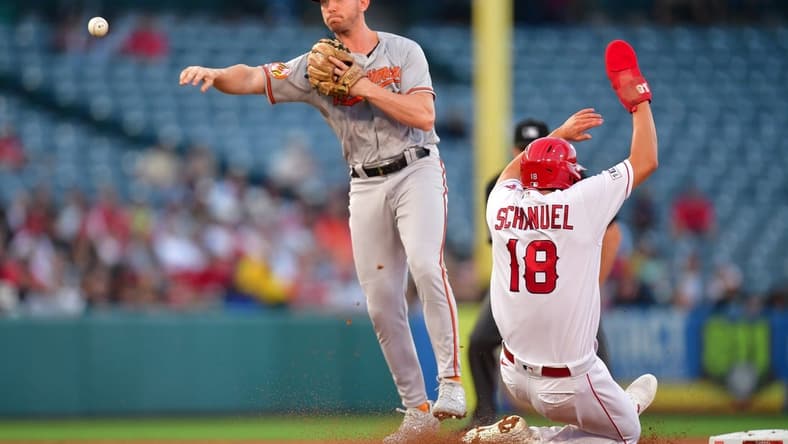 Sep 4, 2023; Anaheim, California, USA; Los Angeles Angels first baseman Nolan Schanuel (18) is out at second as Baltimore Orioles second baseman Jordan Westburg (11) throws to first for the out against designated hitter Brandon Drury (23) during the first inning at Angel Stadium. Mandatory Credit: Gary A. Vasquez-USA TODAY Sports